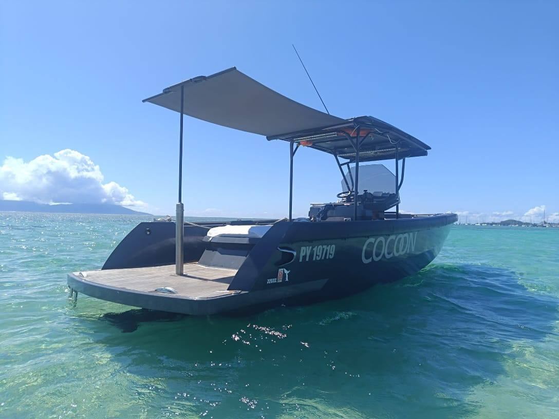The Cocoon luxury RIB under way with its canopy deployed, Bora Bora